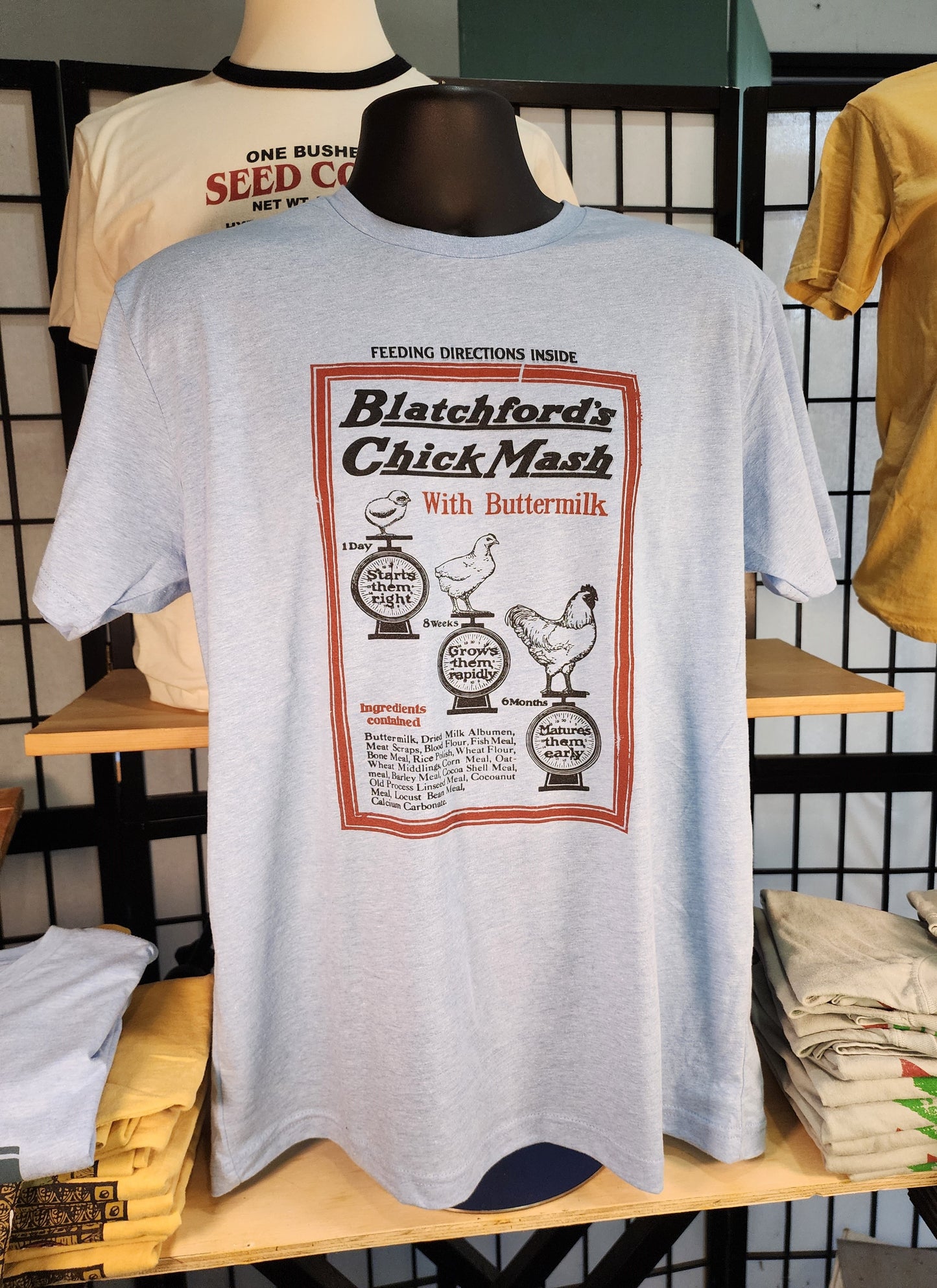 Vintage Seed Bag design; "Blatchford's Chick Mash" Waukegan, Illinois, Next-Level tee, Colombia Blue Heather