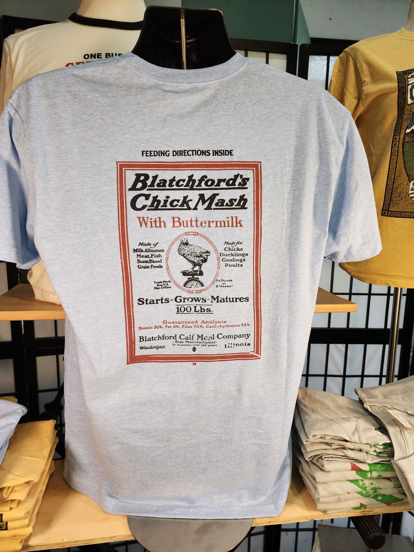 Vintage Seed Bag design; "Blatchford's Chick Mash" Waukegan, Illinois, Next-Level tee, Colombia Blue Heather